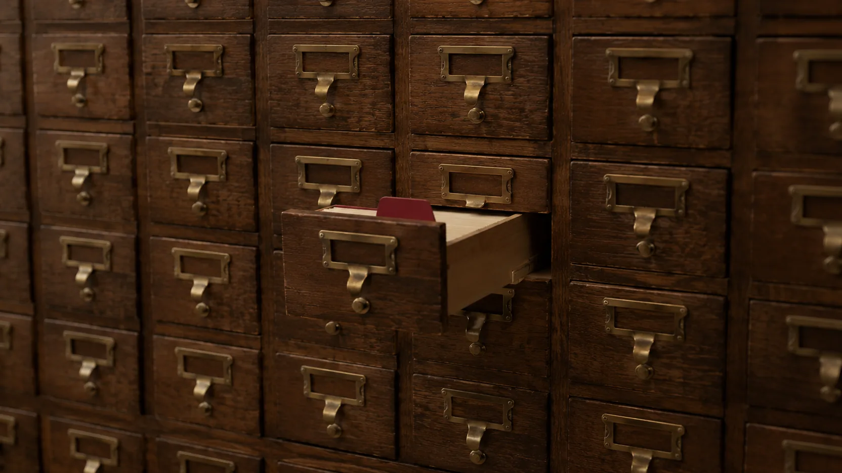Oak card-catalog drawers, one open with a red index tab